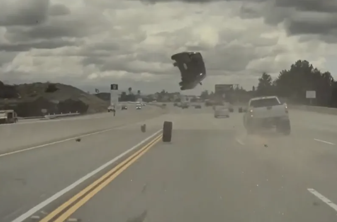 Shocking moment car launched into the air after being hit by stray tyre ...